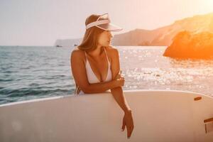 Woman sea sup. Close up portrait of happy young caucasian woman with long hair looking at camera and smiling. Cute woman portrait in a white bikini posing on sup board in the sea photo