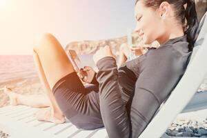 Man woman laptop sea. Working remotely on seashore. Happy successful couple, freelancers working on sea beach, relieves stress from work to restore life balance. Freelance, remote work on vacation photo