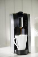 A coffe machine is brewing coffee. photo