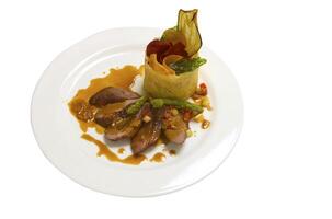 Pieces of duck with the sweet sauce and the vegetables photo