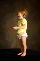 Small girl listens to the music photo