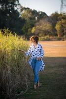 Fashion shot of a beautiful boho style girl on nature background. Boho, hippie. photo