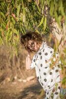 Fashion shot of a beautiful boho style girl on nature background. Boho, hippie. photo