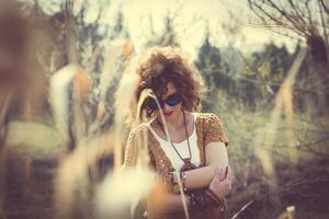 Fashion shot of a beautiful boho style girl on nature background. Boho, hippie photo