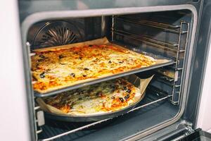 Homemade pizza coming out of oven. Healthy food concept. Selective focus. photo