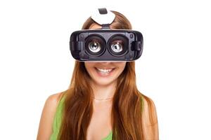 portrait of happy smiling young beautiful girl getting experience using VR-headset glasses of virtual reality, big eyes, funny style, isolated photo