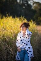 Fashion shot of a beautiful boho style girl on nature background. Boho, hippie. photo