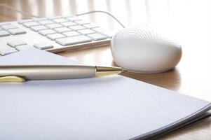 Modern aluminum computer keyboards, mouse and notebook photo