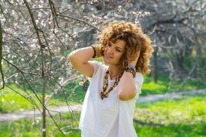 Fashion shot of a beautiful boho style girl on nature background. Boho, hippie. photo