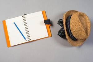 Packed suitcase of vacation items on grey background, top view. photo