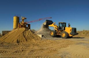 Bulldozer loads crushed stone into the scoop photo