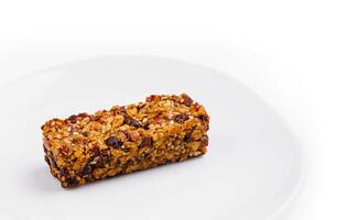 granola bar on white plate isolated on white background photo