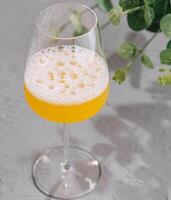 Glass of delicious fresh orange smoothie photo