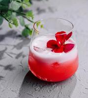 red cocktail white foam red flower photo