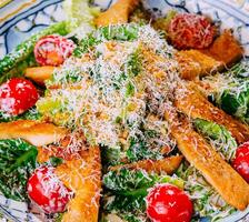 Fresh healthy caesar salad close up photo