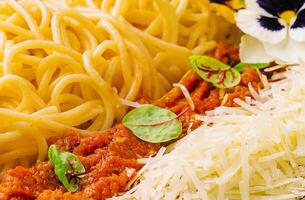 Spaghetti with bolognese sauce and grated parmesan cheese photo