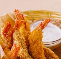 Tempura Shrimps in wood basket on the table photo