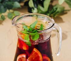 Full jug of pomegranate juice with lemon photo