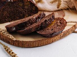 Black round bread on a cutting board photo