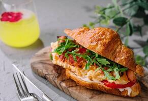 Fresh sandwich with bacon and scrambled eggs photo