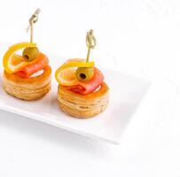 Salmon rolled fillet in pastries isolated on white photo