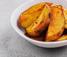 Roasted potato wedges with spices photo