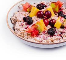 porridge with fruits on bowl isolated photo