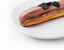 Eclair topped with chocolate on white plate photo