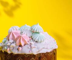 Traditional Easter cakes with meringue on yellow background photo