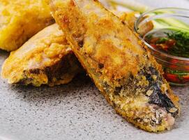 close up fried fish fillet with vegetables photo