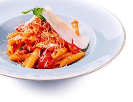 Italian style pasta with tomato sauce and parmesan photo