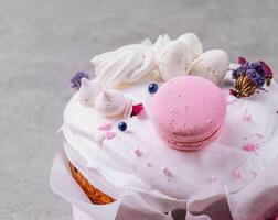 Easter cake decorated with meringues and macarons photo