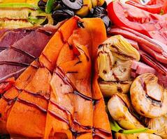 salad of various meats with mushrooms, carrots and lettuce leaves photo