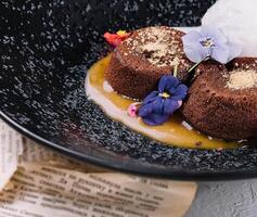 Chocolate lava cake with ice cream served on plate photo
