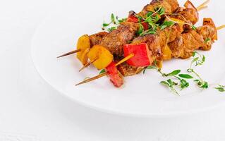 Chicken skewers with slices of sweet peppers photo