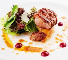 Slices of grilled duck breast fillet with salad photo