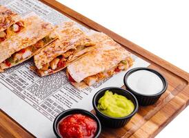 Mexican quesadilla with chicken on wooden board photo