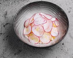 Summer cold soup - okroshka in a ceramic bowl photo
