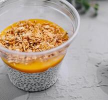 Chia pudding with mango and granola top view photo