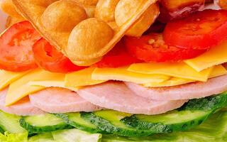 Belgian waffles with ham, cheese and salad close up photo