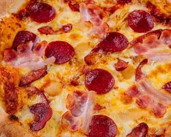 pepperoni pizza with bacon close up photo