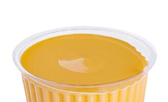 Mustard sauce in plastic bowl isolated on white background photo