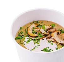 Cream soup with mushrooms isolated on white photo