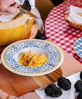 Chef Grating Truffle Shavings on Pasta with Parmesan photo