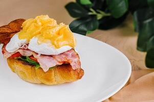 fresh croissant with smoked salmon and croissant sandwich with bacon photo