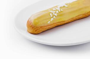Delicious eclair with custard on plate top view photo