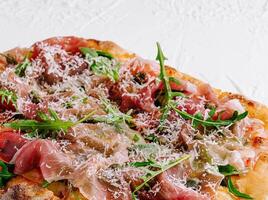 square pizza with prosciutto and arugula photo