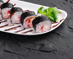 sushi maki rolls with tobiko caviar inside photo