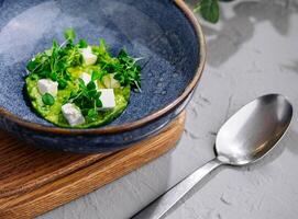 Broccoli, spinach cream soup in a bowl photo