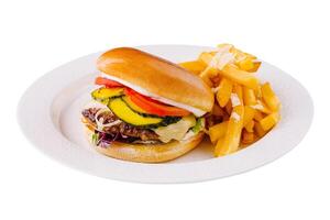 Classic cheeseburger with fries on white plate photo